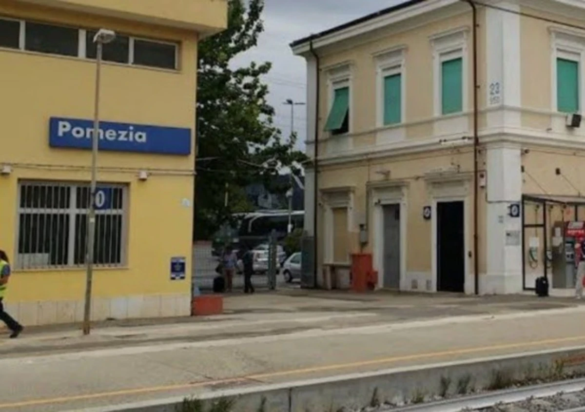 Stazione affollata con viaggiatori in attesa durante ritardi e sospensione della circolazione